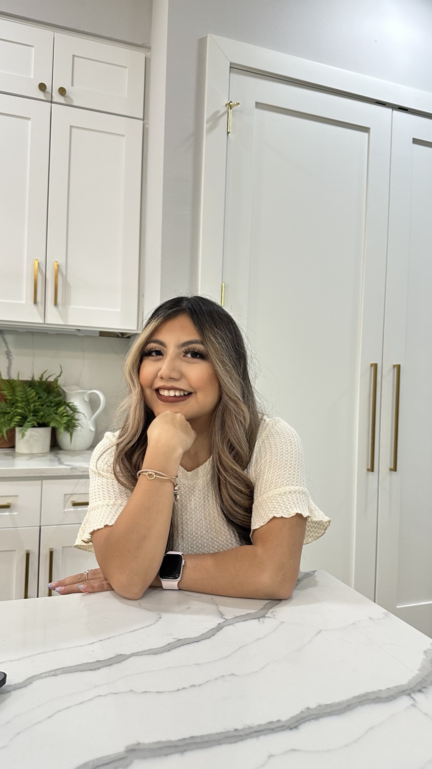 Stefani Vazquez, owner of SV Bookkeeping Solutions smiling in a cream blouse